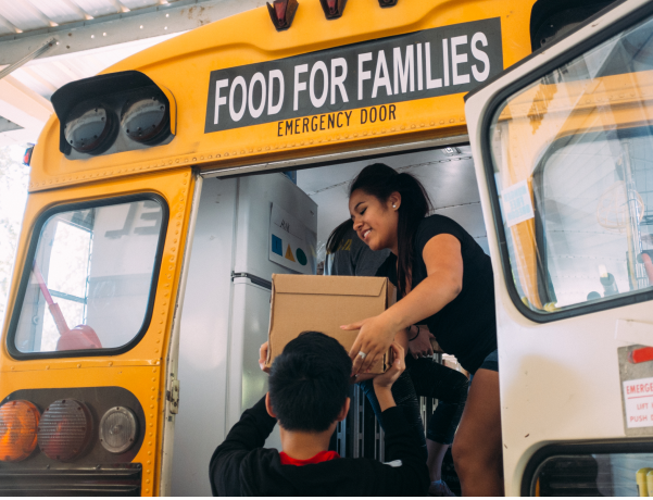 Woman unpacking food from bus for Oregon Food Bank