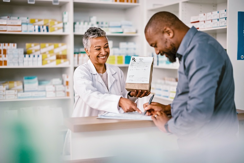 A pharmacist providing service to a patron