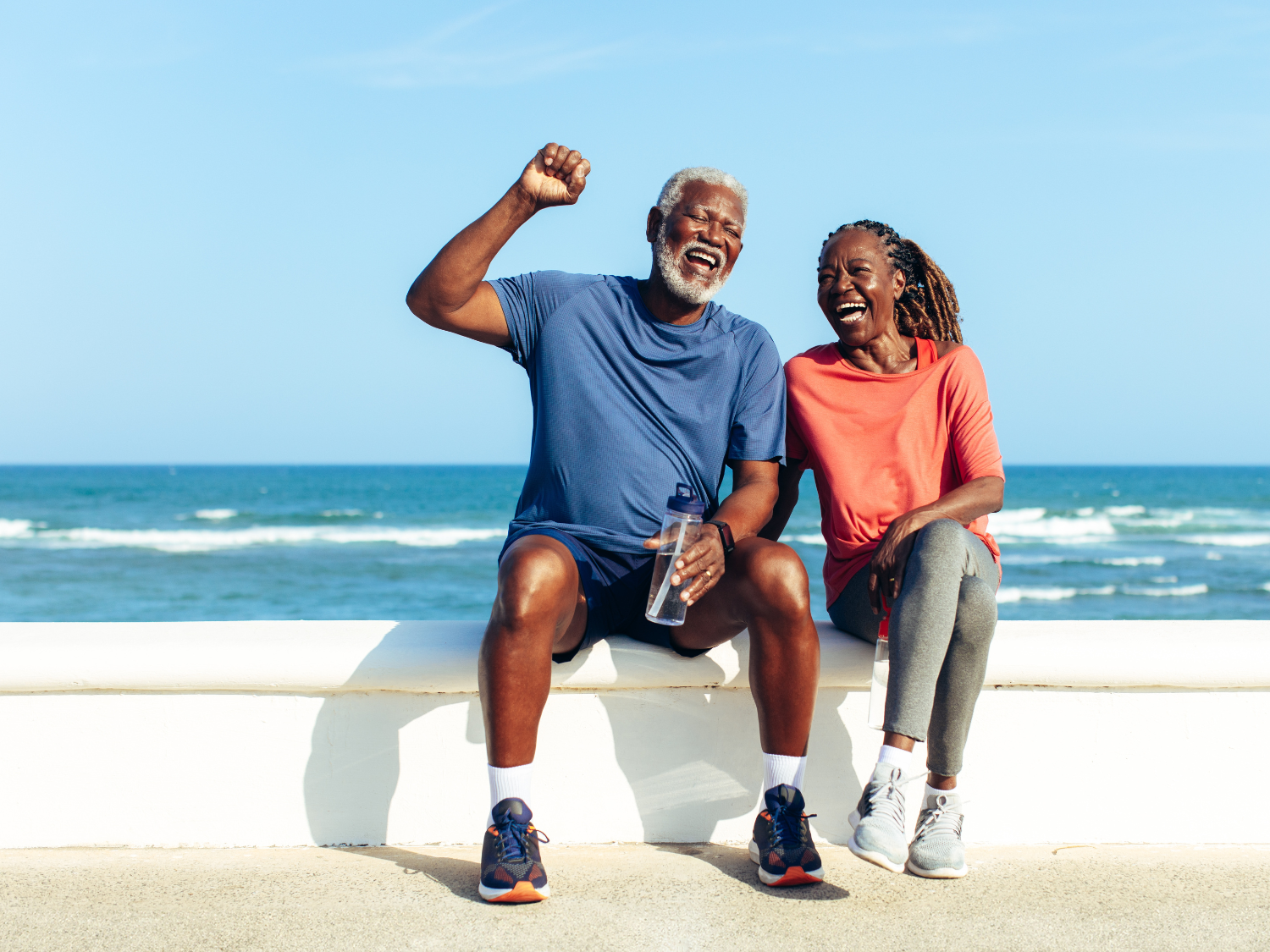A couple sitting by the ocean