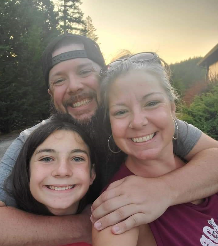 JT (Jonathan Taylor) hugging smiling family.