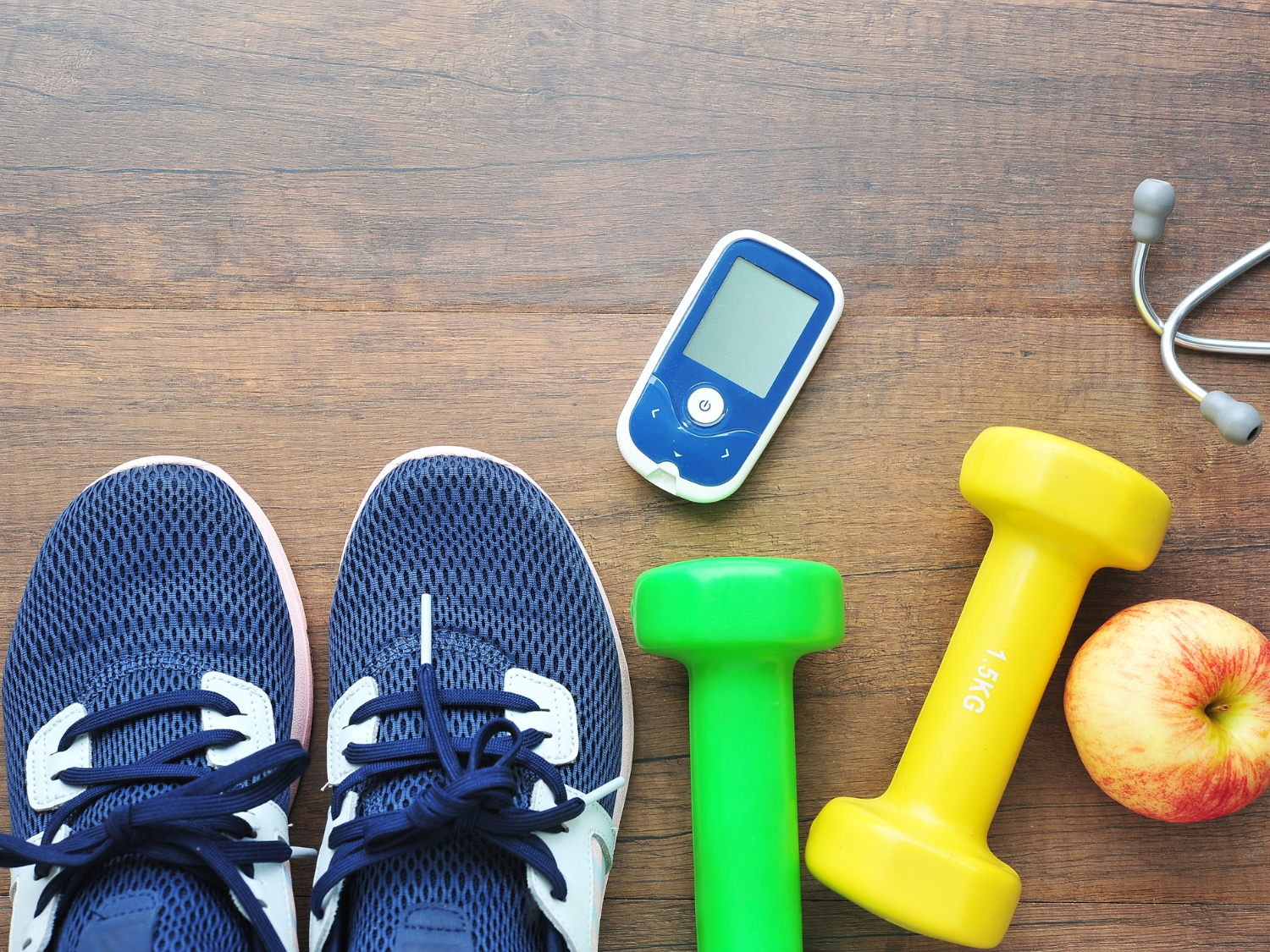 Workout gear, including shoes, hand weights, ear pods, apple and glucose monitor.
