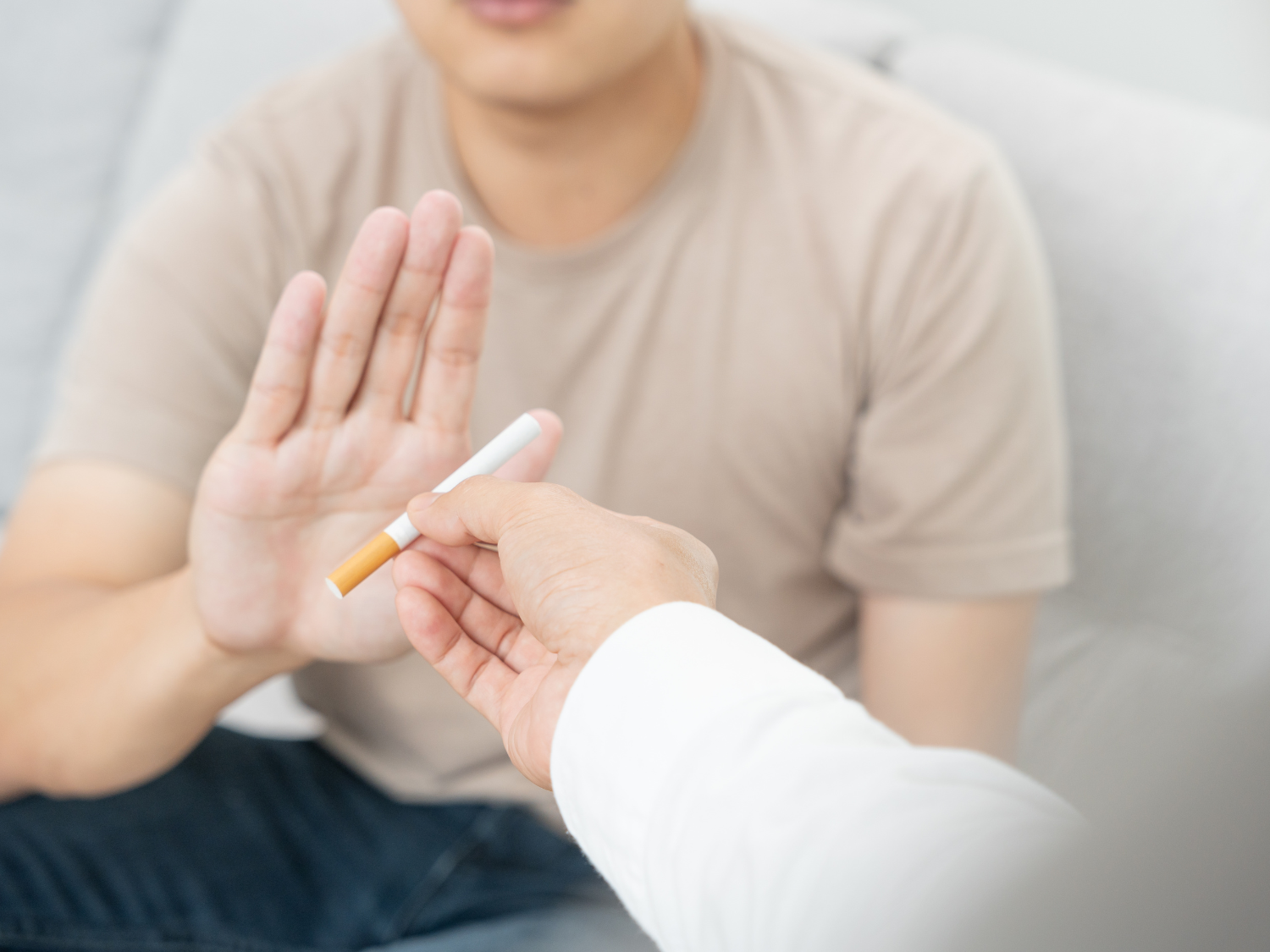 Person pushes away a cigarette