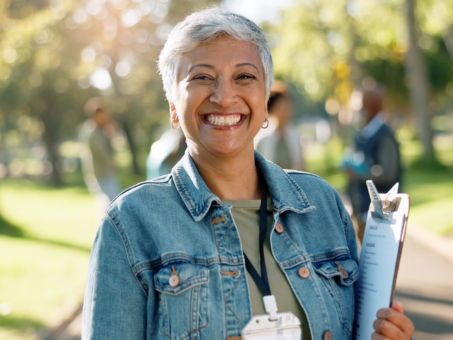 Woman smiling outside and holding her water bottle