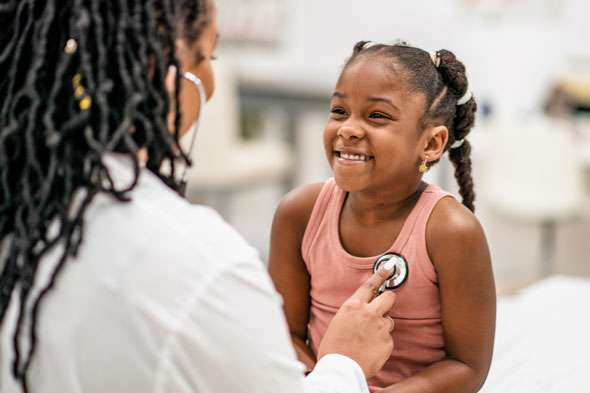 A little girl getting a checkup at the clinic