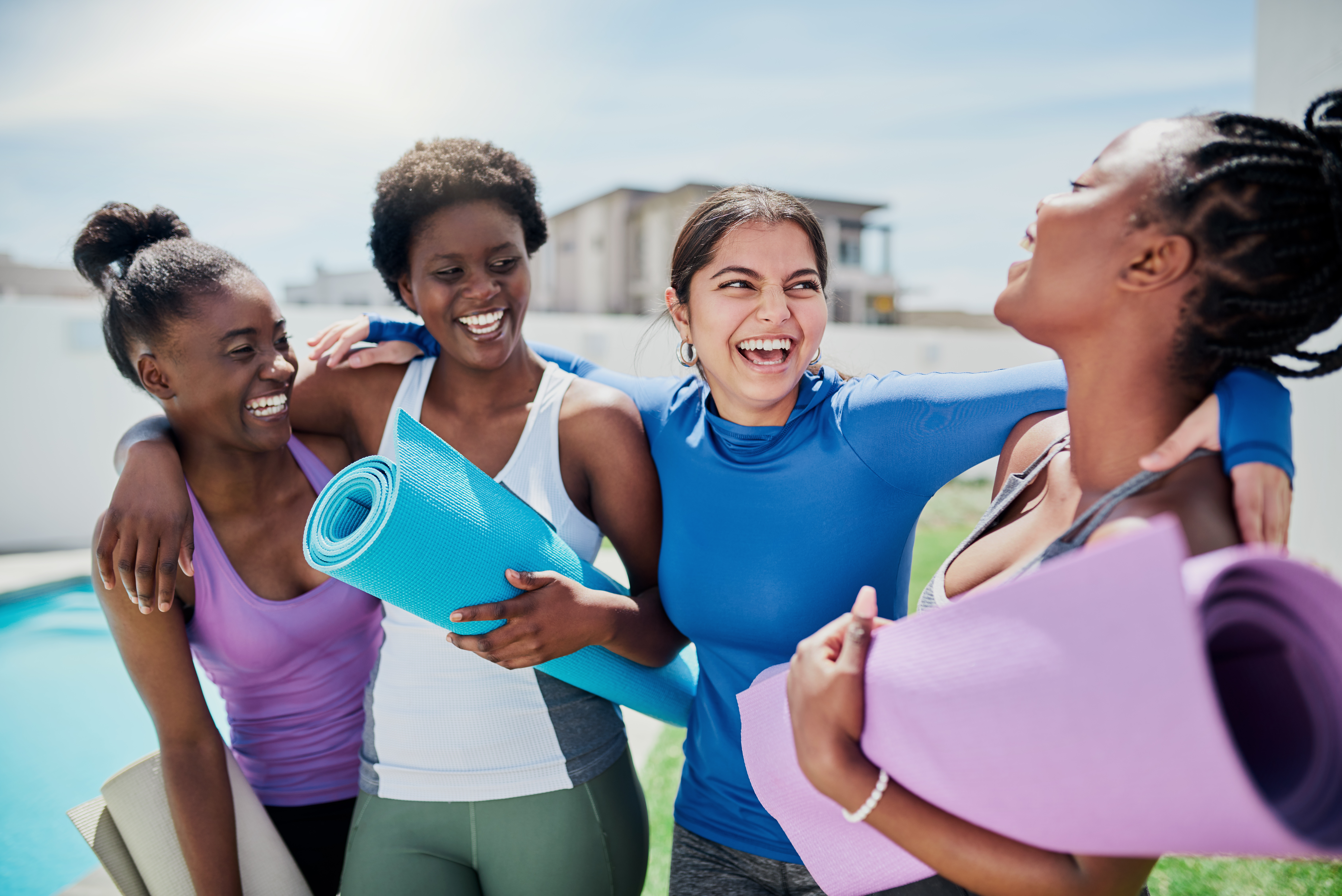 Women holding yoga mats