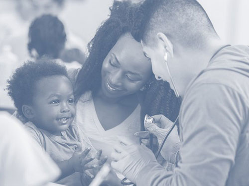 Healthcare worker measures child's heartbeat