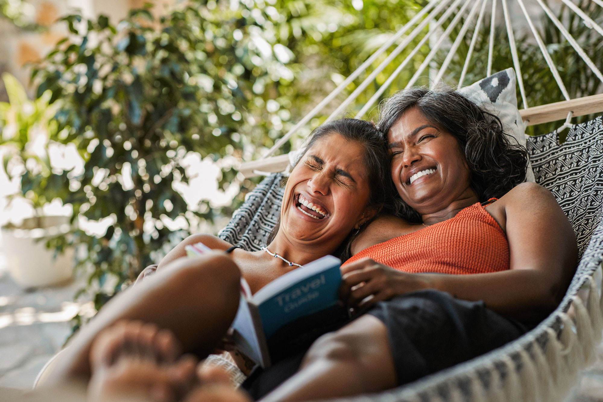 Women in hammock laughing
