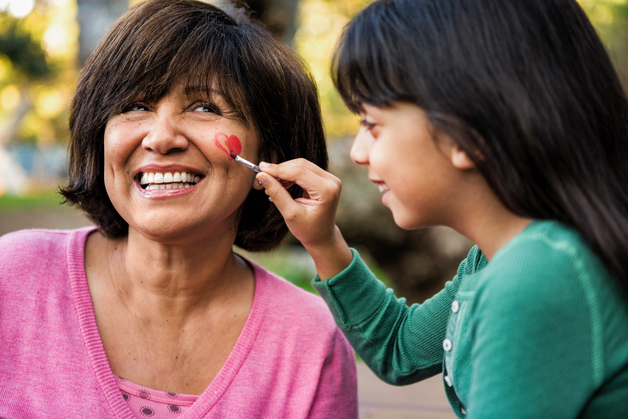Girl paints Mom's face
