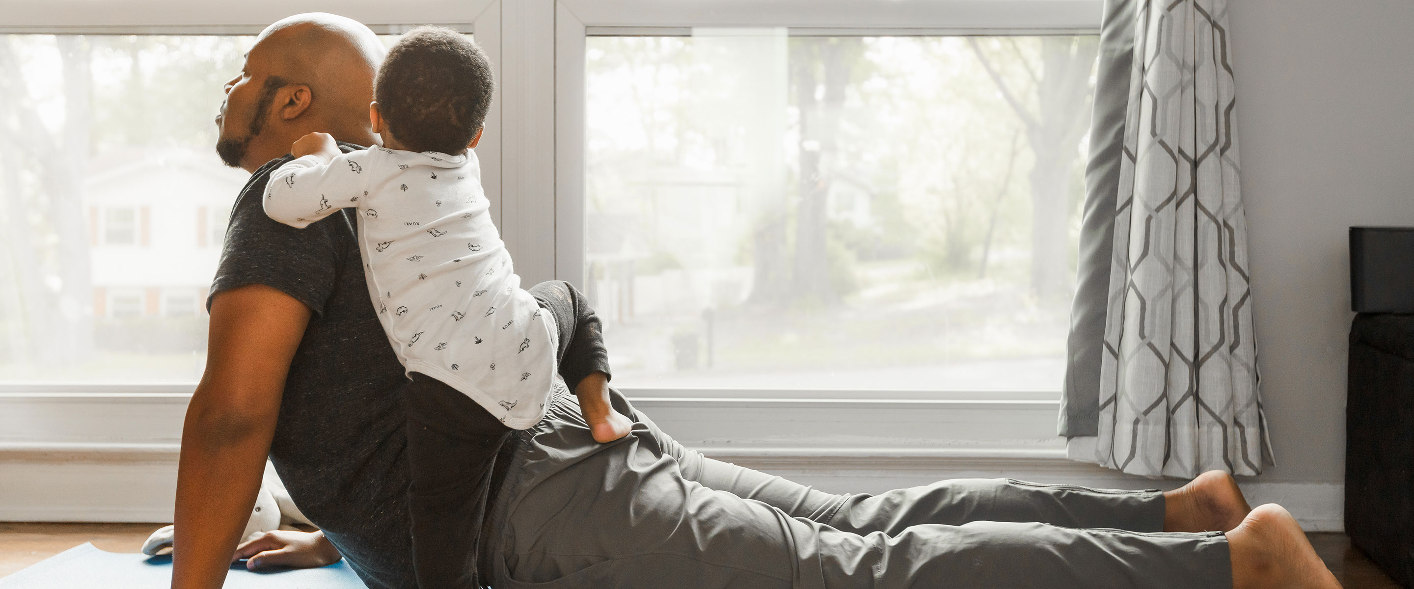 Father doing yoga with child